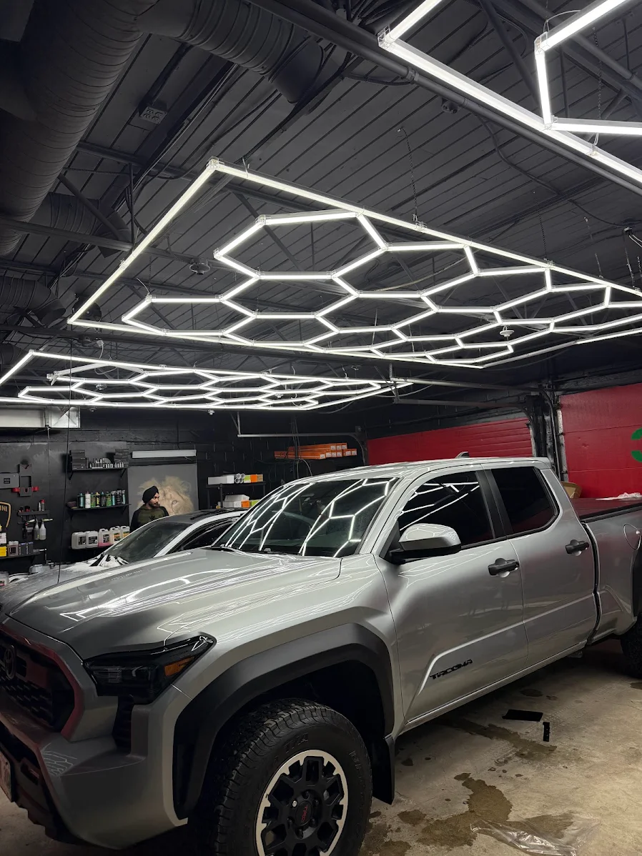 WPEG Customs Winnipeg detailing bay with hexagon LED lighting and Toyota Tacoma